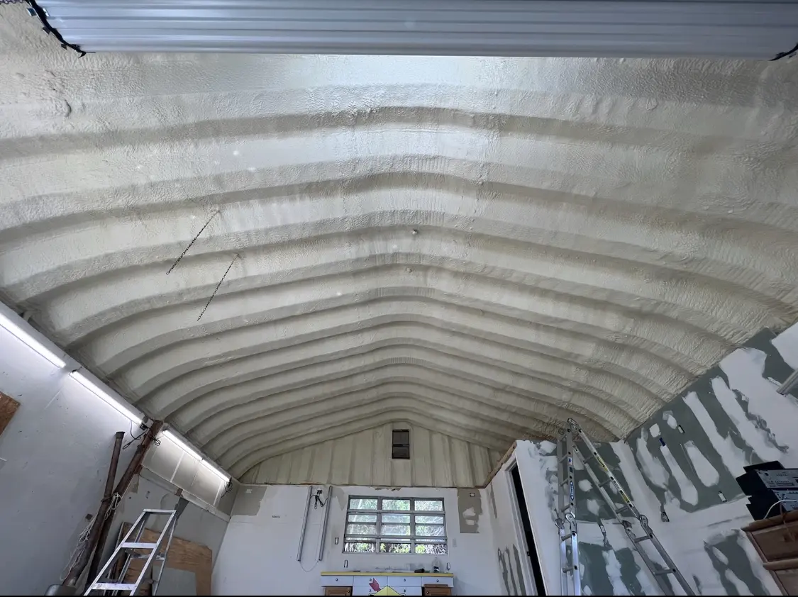Spray polyurethane foam applied to the underside of a metal roof deck in Attalla